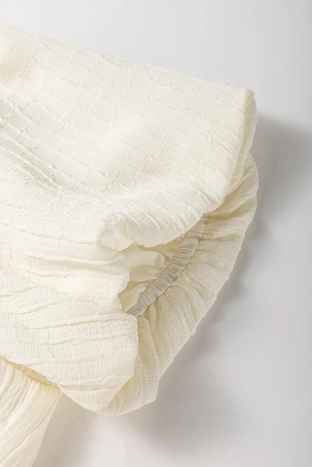 White Textured Bow Ties Front Bubble Hem Puff Short Sleeve Blouse